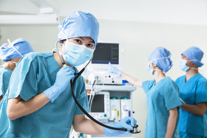 Team of surgeons in the operating room, female surgeon holding s